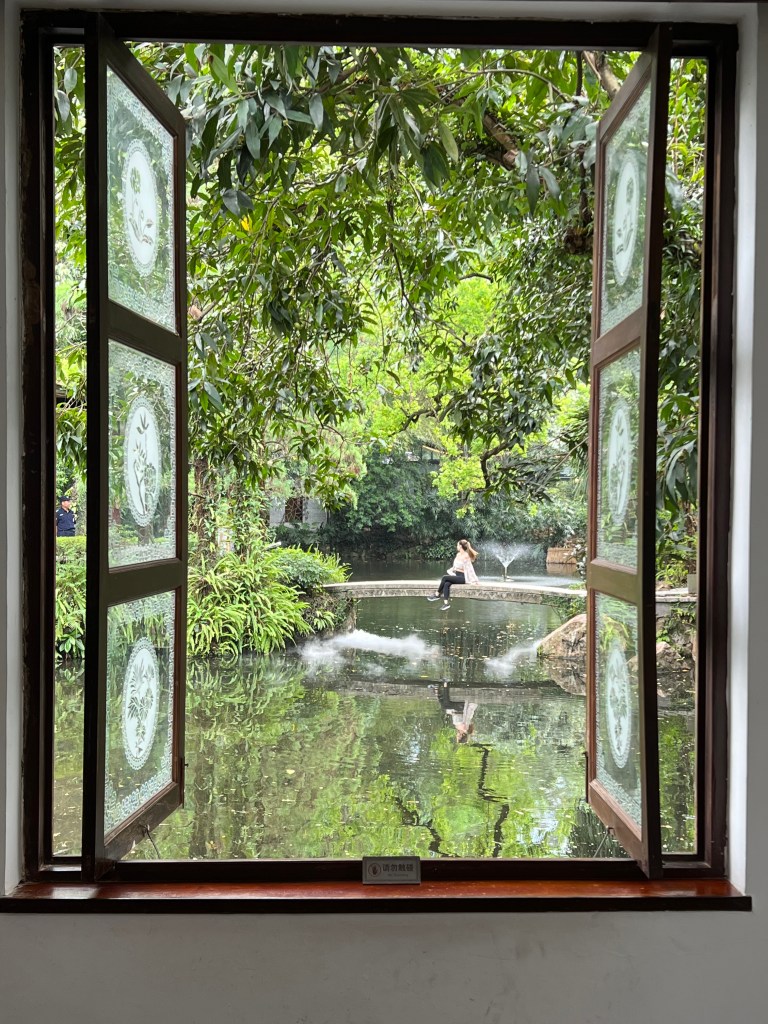 Garden pond and fountain seen through an open window, Guangzhou, China - photo by Sakine Gulec
